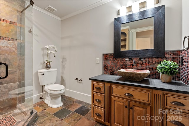 bathroom with stone finish flooring, crown molding, a stall shower, backsplash, and vanity