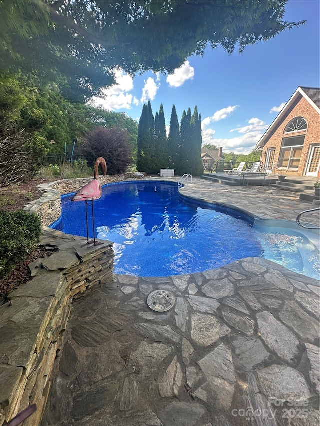 outdoor pool featuring a patio