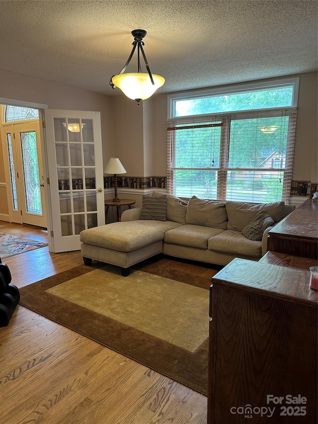 living room with wood finished floors and a textured ceiling