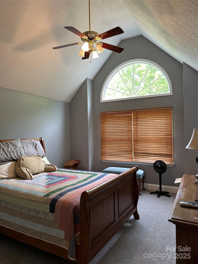 bedroom featuring vaulted ceiling, a textured ceiling, carpet flooring, a ceiling fan, and baseboards
