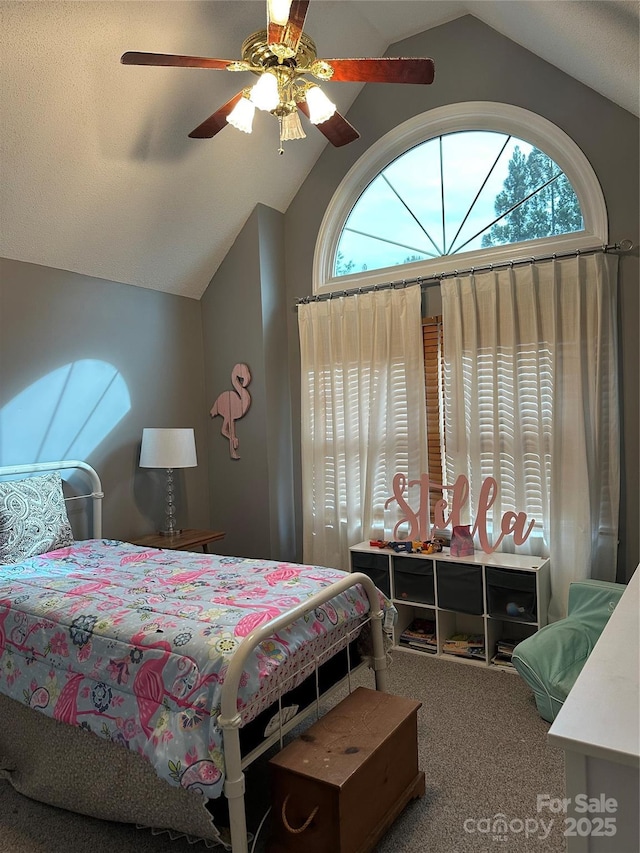 carpeted bedroom featuring vaulted ceiling and a ceiling fan