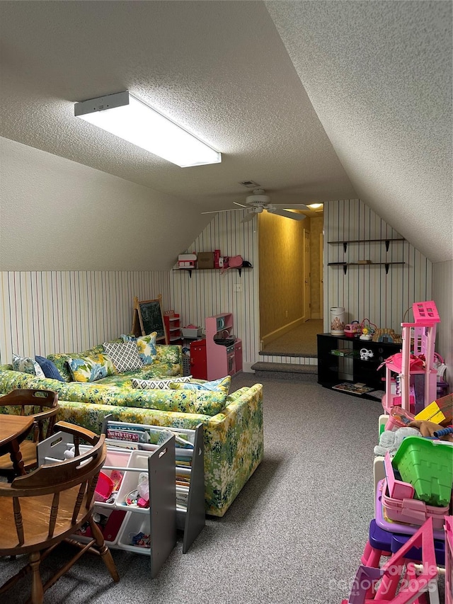 bonus room with a textured ceiling, lofted ceiling, and carpet