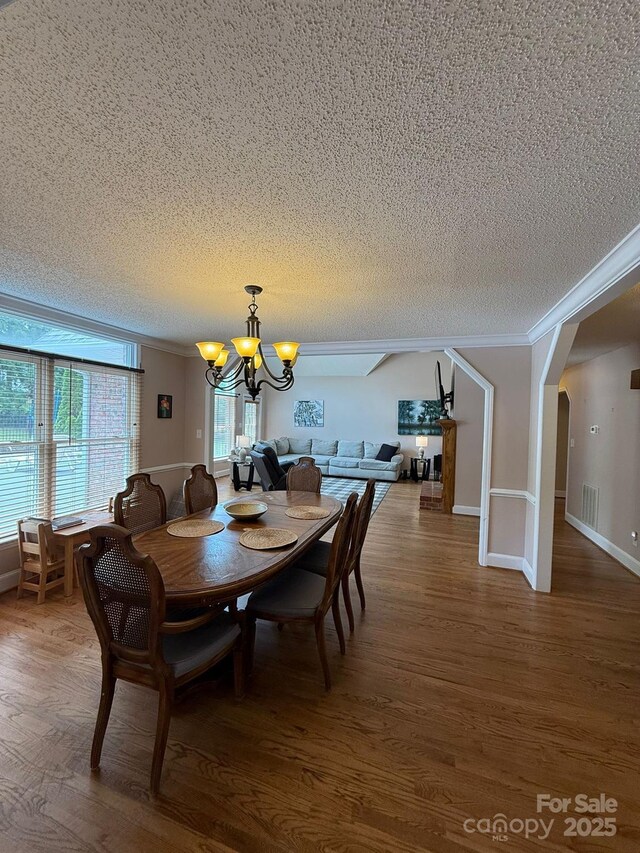 504 Johnsfield Rd, Shelby, NC 28150 - dining space featuring a textured ceiling, a chandelier, wood finished floors, crown molding, and baseboards