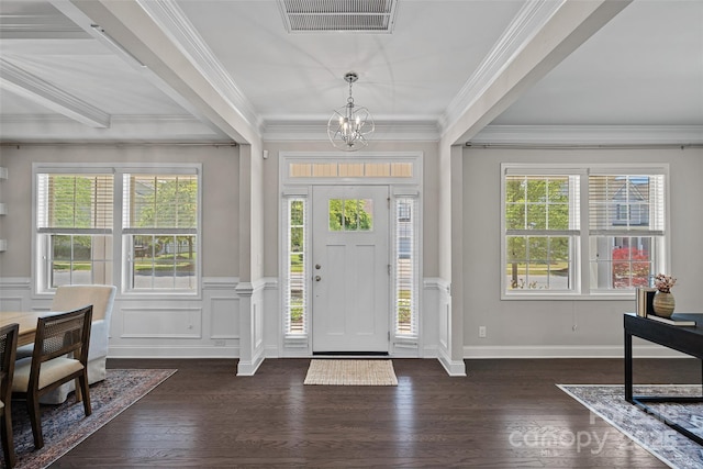 10906 Charmont Pl, Huntersville, NC 28078 - entrance foyer featuring a chandelier, dark wood-type flooring, crown molding, wainscoting, and a decorative wall
