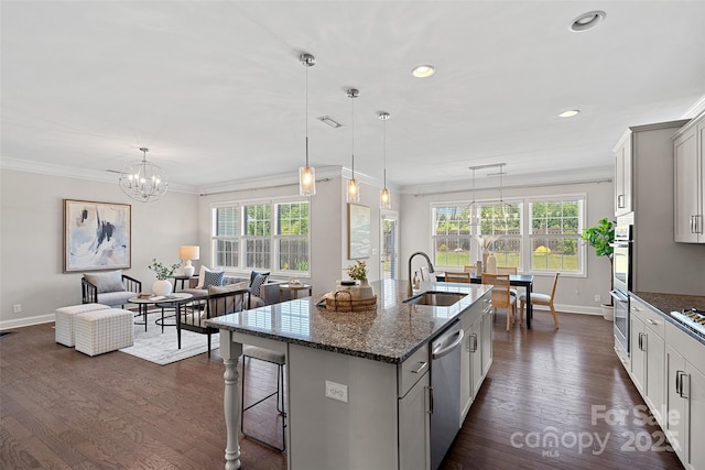 10906 Charmont Pl, Huntersville, NC 28078 - kitchen featuring a sink, baseboards, appliances with stainless steel finishes, a kitchen bar, and a chandelier
