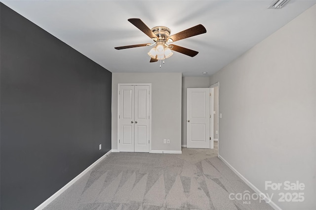 10906 Charmont Pl, Huntersville, NC 28078 - unfurnished bedroom featuring carpet flooring, baseboards, a closet, and a ceiling fan