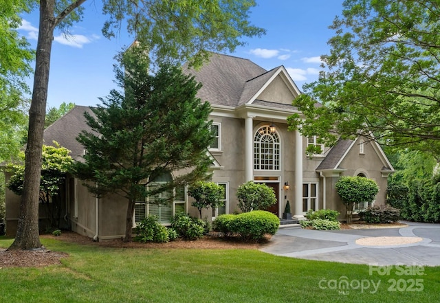 4429 Cameron Oaks Dr, Charlotte, NC 28211 - neoclassical / greek revival house featuring stucco siding, a shingled roof, and a front lawn
