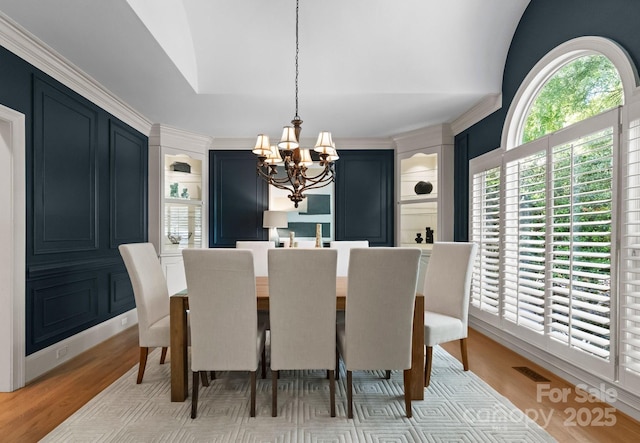 4429 Cameron Oaks Dr, Charlotte, NC 28211 - dining room with light wood finished floors and a notable chandelier