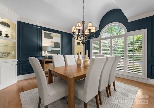 4429 Cameron Oaks Dr, Charlotte, NC 28211 - dining area featuring a chandelier, light wood-style floors, and crown molding