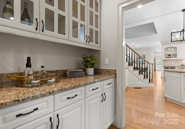 4429 Cameron Oaks Dr, Charlotte, NC 28211 - bar with light wood-style flooring, recessed lighting, visible vents, stairway, and tasteful backsplash