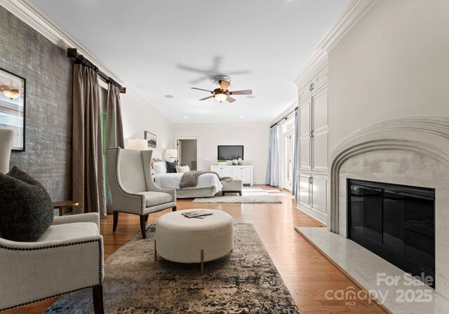 4429 Cameron Oaks Dr, Charlotte, NC 28211 - living room with ornamental molding, a high end fireplace, a ceiling fan, and light wood-style floors