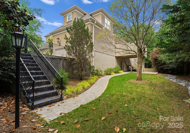 4429 Cameron Oaks Dr, Charlotte, NC 28211 - view of property exterior with stucco siding, a wooden deck, a lawn, and stairs