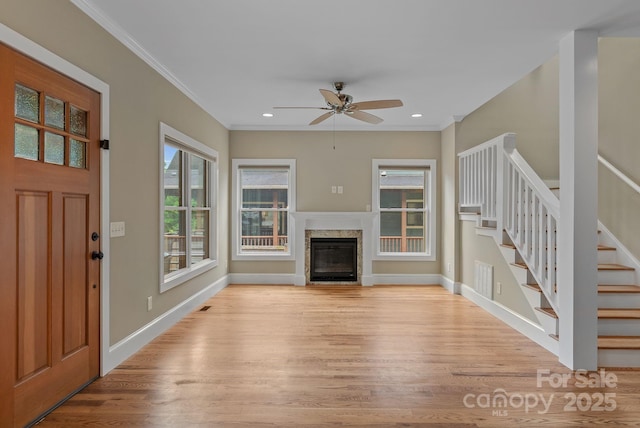38 Unadilla Aly, Asheville, NC 28803 - unfurnished living room with light wood finished floors, stairway, a ceiling fan, ornamental molding, and baseboards