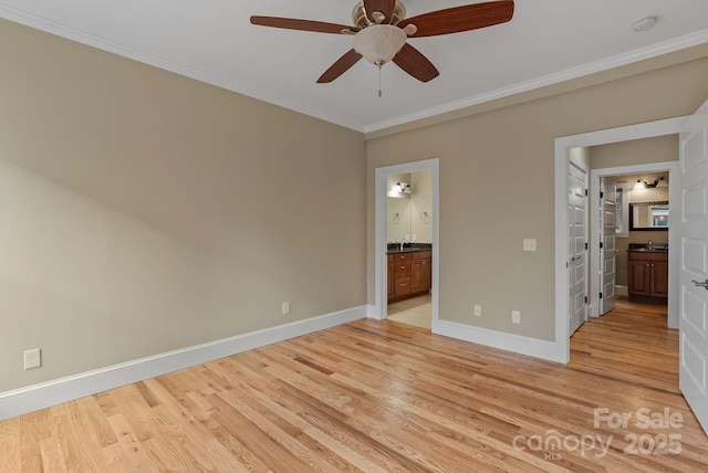 38 Unadilla Aly, Asheville, NC 28803 - unfurnished bedroom featuring connected bathroom, ornamental molding, light wood-type flooring, baseboards, and a sink