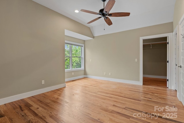 38 Unadilla Aly, Asheville, NC 28803 - unfurnished bedroom with vaulted ceiling, baseboards, light wood-style floors, a walk in closet, and recessed lighting