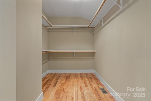 38 Unadilla Aly, Asheville, NC 28803 - spacious closet featuring wood finished floors and vaulted ceiling