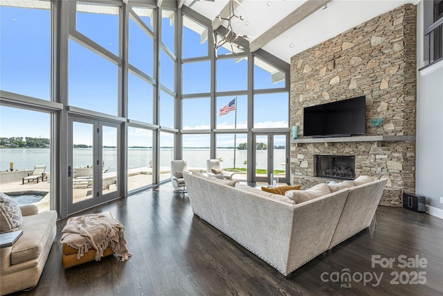 3386 Governors Island Dr, Denver, NC 28037 - living room featuring a high ceiling, a fireplace, dark wood finished floors, a wall of windows, and beamed ceiling