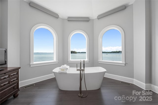 3386 Governors Island Dr, Denver, NC 28037 - bathroom with plenty of natural light, a soaking tub, and wood finished floors