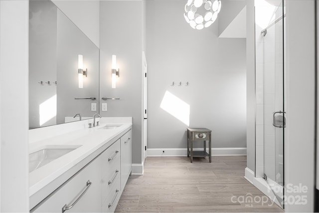 3386 Governors Island Dr, Denver, NC 28037 - bathroom with a stall shower, wood finished floors, baseboards, and double vanity