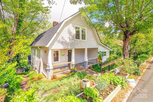 9 N St, Weaverville, NC 28787 - dutch colonial with a gambrel roof, a chimney, covered porch, roof with shingles, and a garden