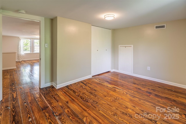 9 N St, Weaverville, NC 28787 - empty room with a smoke detector, dark wood-style flooring, and baseboards