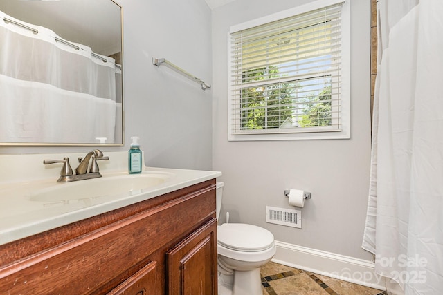 bathroom featuring toilet, vanity, baseboards, and curtained shower