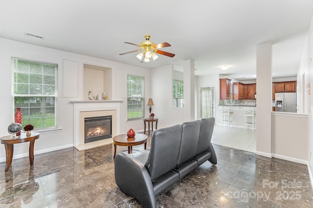 15037 Taylor Ridge Ln Unit 25, Charlotte, NC 28273 - living area with ceiling fan, a glass covered fireplace, baseboards, and marble finish floors