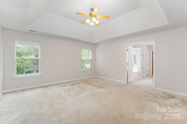 15037 Taylor Ridge Ln Unit 25, Charlotte, NC 28273 - empty room with a raised ceiling, a ceiling fan, light carpet, and baseboards