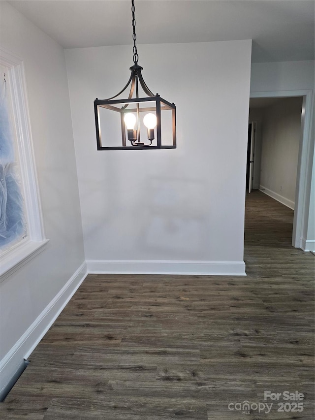 1900 Walkup Ave Unit 1, Monroe, NC 28110 - unfurnished dining area featuring baseboards, a chandelier, and dark wood-type flooring
