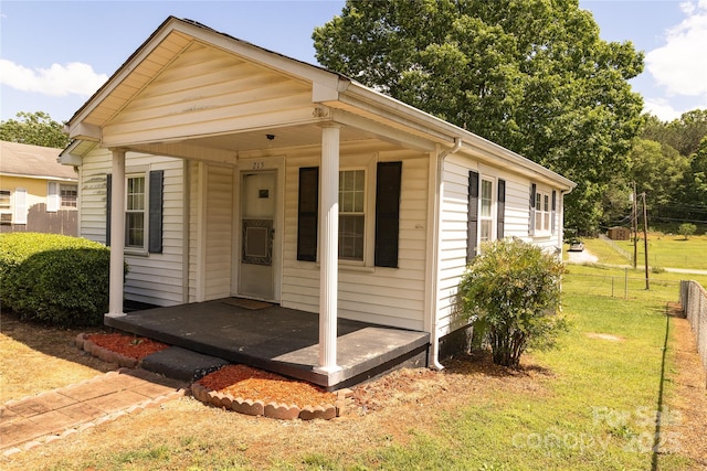 bungalow-style home featuring fence and a front yard