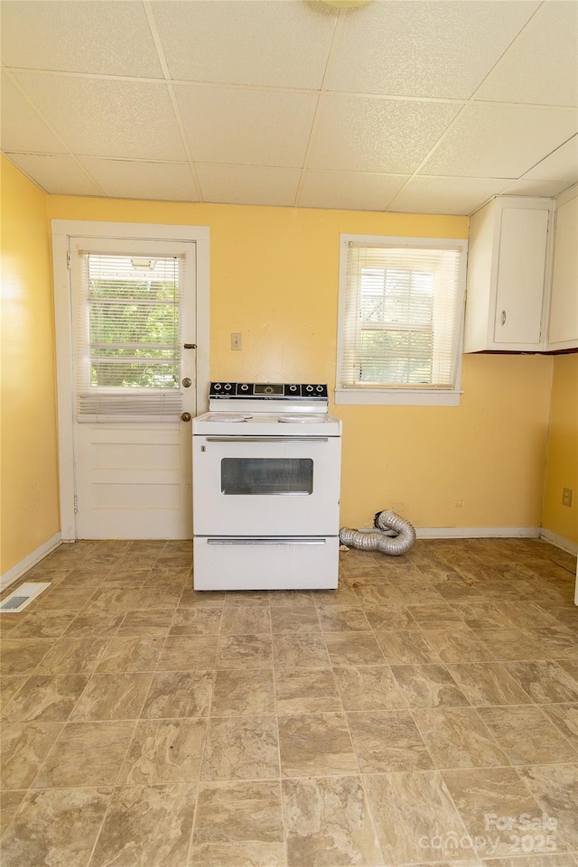 kitchen with white electric stove, a wealth of natural light, and a paneled ceiling