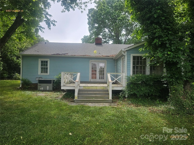 6407 Market St, Charlotte, NC 28215 - back of house with a chimney, a deck, a yard, french doors, and roof with shingles