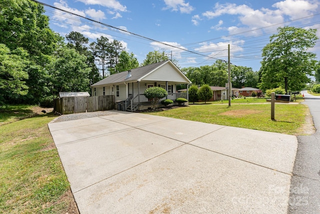 201 Easy St, Concord, NC 28027 - ranch-style house featuring a porch, driveway, and view of wooded area
