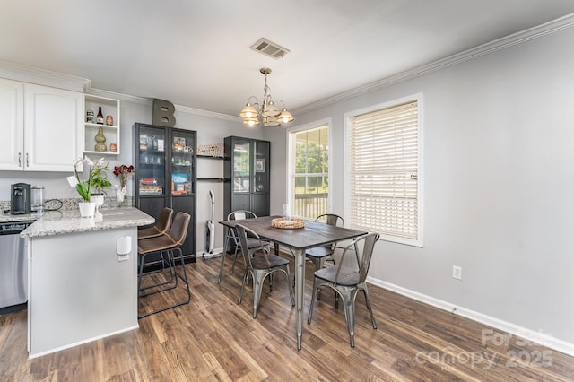 201 Easy St, Concord, NC 28027 - dining area with a chandelier, ornamental molding, dark wood finished floors, and baseboards