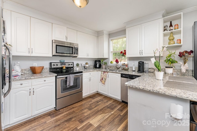 201 Easy St, Concord, NC 28027 - kitchen featuring appliances with stainless steel finishes, dark wood-style floors, light stone countertops, white cabinets, and crown molding