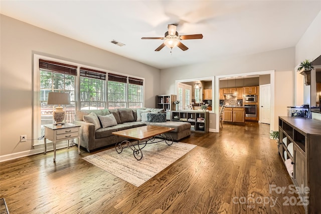 7600 Ridgefield Dr, Charlotte, NC 28269 - living room featuring visible vents, baseboards, a ceiling fan, and dark wood-style floors