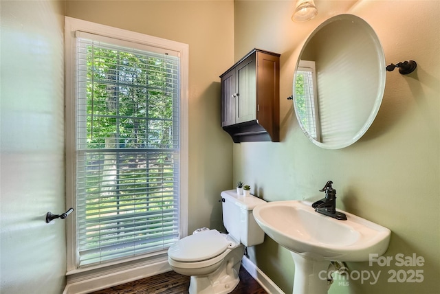 7600 Ridgefield Dr, Charlotte, NC 28269 - half bath featuring toilet, a sink, and wood finished floors