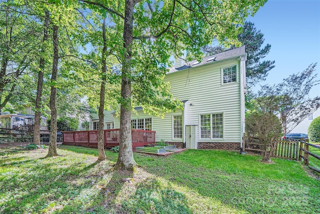 7600 Ridgefield Dr, Charlotte, NC 28269 - back of property with a fenced backyard, a deck, and a lawn