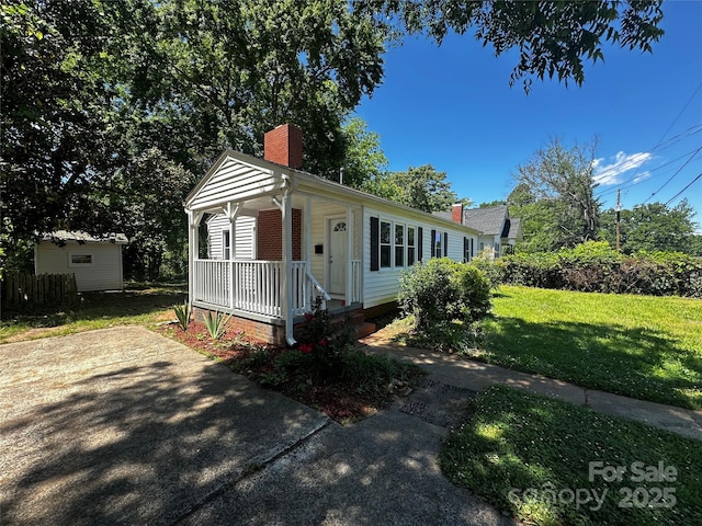 1119 Sanders St, Rock Hill, SC 29732 - bungalow-style home featuring a porch, a chimney, and a front yard