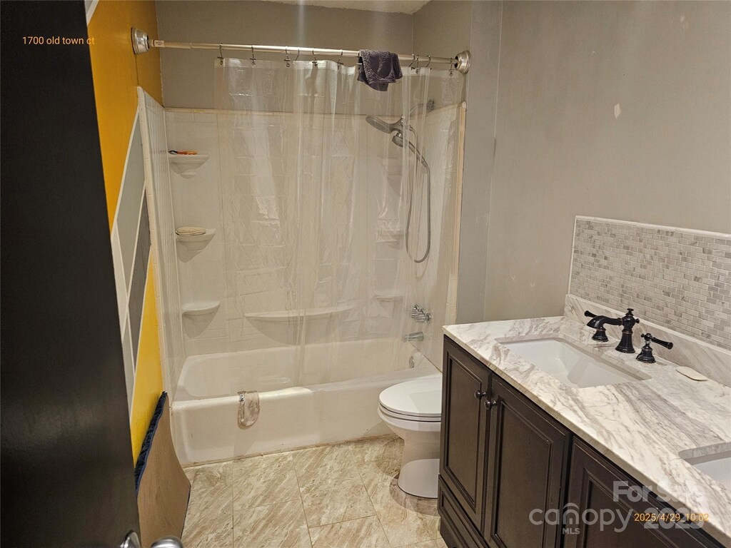 1700 Old Towne Ct, Charlotte, NC 28217 - bathroom featuring toilet, shower / tub combo, and vanity