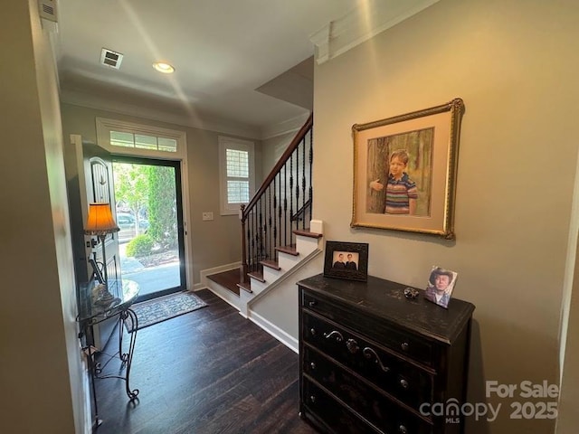 entrance foyer with dark wood finished floors, stairway, baseboards, recessed lighting, and crown molding