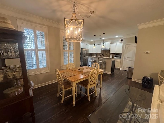 dining area featuring a chandelier, baseboards, dark wood-style flooring, ornamental molding, and recessed lighting