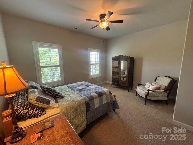 carpeted bedroom featuring baseboards and a ceiling fan