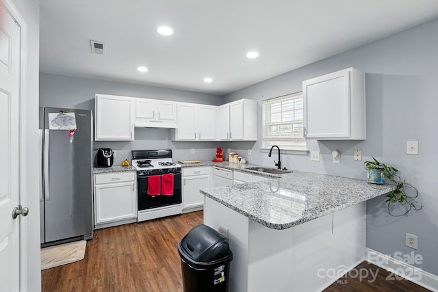 10431 Plantain Ct, Charlotte, NC 28213 - kitchen with freestanding refrigerator, gas stove, a sink, a peninsula, and white cabinets