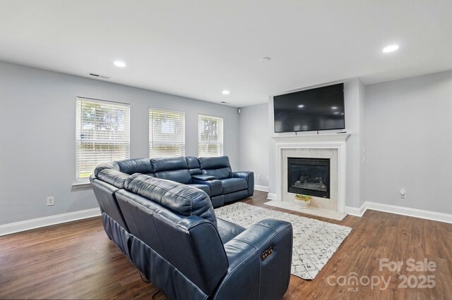 10431 Plantain Ct, Charlotte, NC 28213 - living area featuring a fireplace with flush hearth, baseboards, dark wood-style floors, and recessed lighting