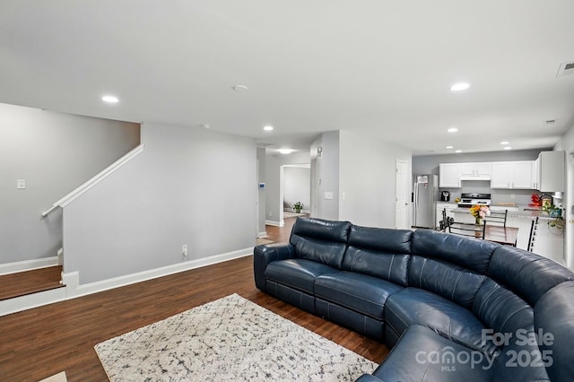 10431 Plantain Ct, Charlotte, NC 28213 - living room with recessed lighting, baseboards, dark wood-style flooring, and stairs