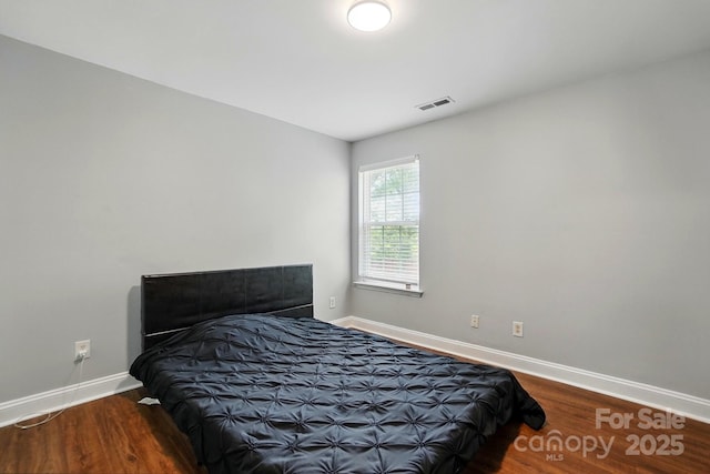 10431 Plantain Ct, Charlotte, NC 28213 - bedroom with baseboards and wood finished floors