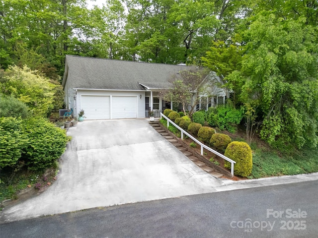 ranch-style house featuring an attached garage and concrete driveway