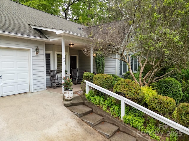 doorway to property with roof with shingles and a porch