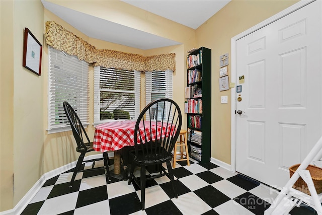 dining area featuring tile patterned floors and baseboards